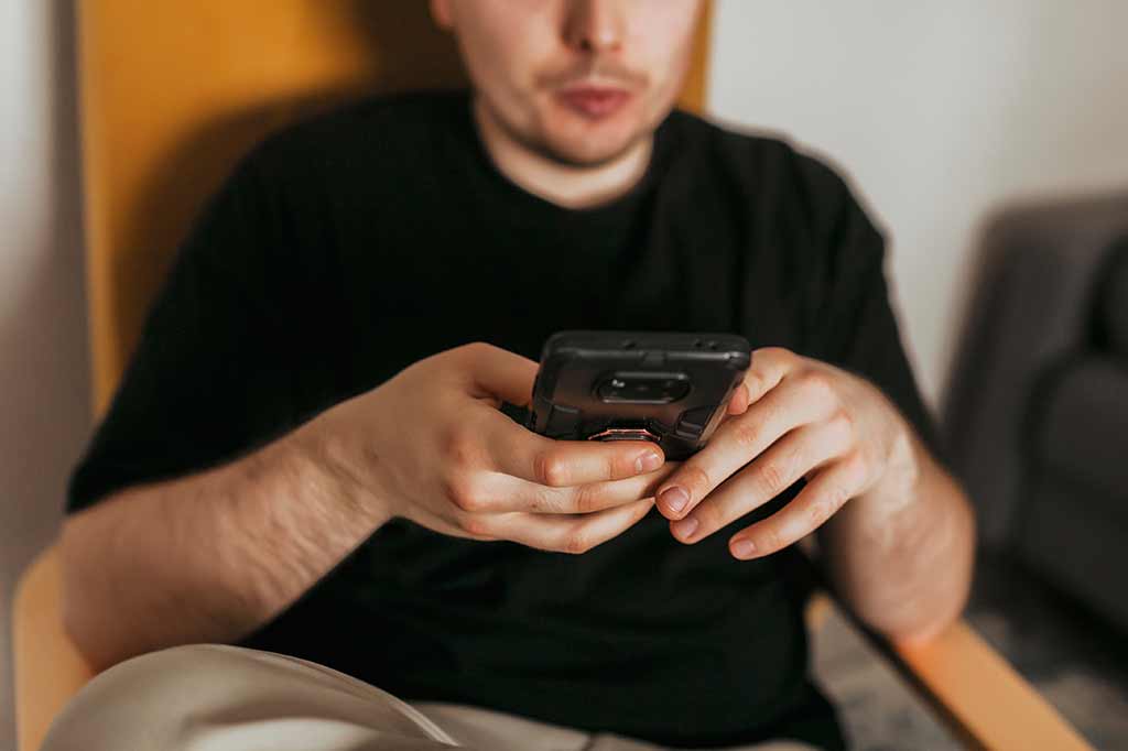 Young Man Using Mobile Phone