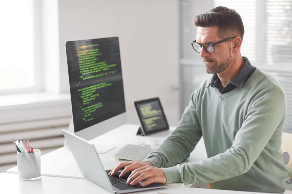 A web developer professional working on his laptop