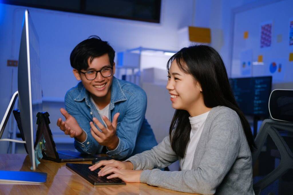 Two web development professionals working happily