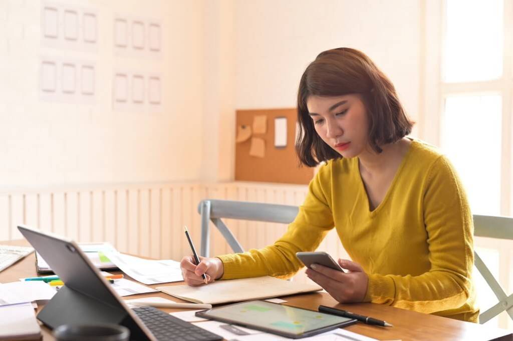 UI UX designer researching on her phone