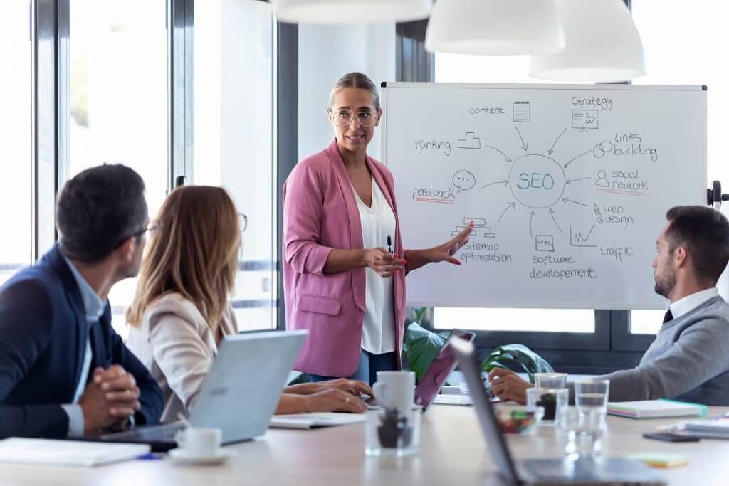 a businesswomen explaining a SEO strategy to her team