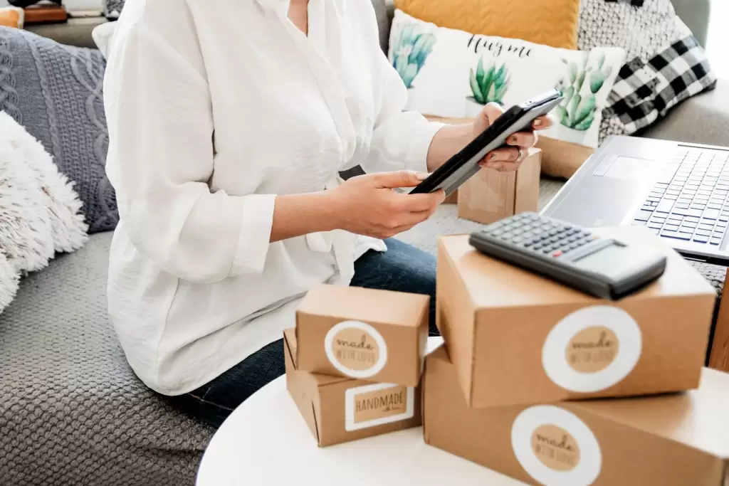 picture of a person having delivery packages and a phone