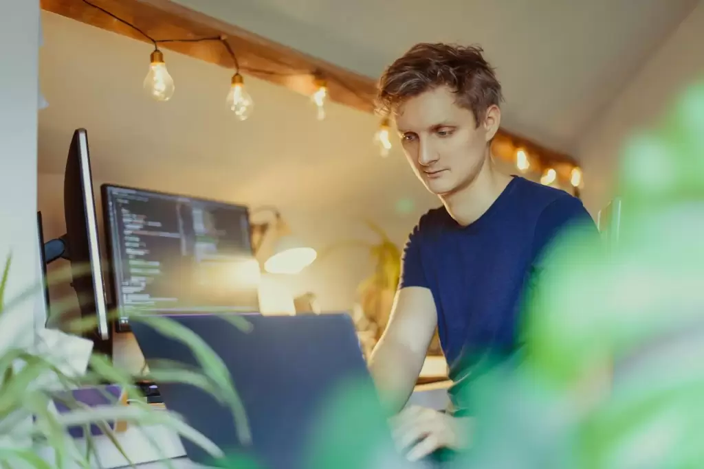 a person with blue tshirt writing code